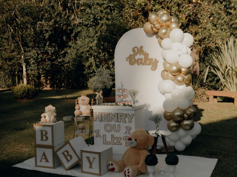 Gold and white balloon setup with plush toys