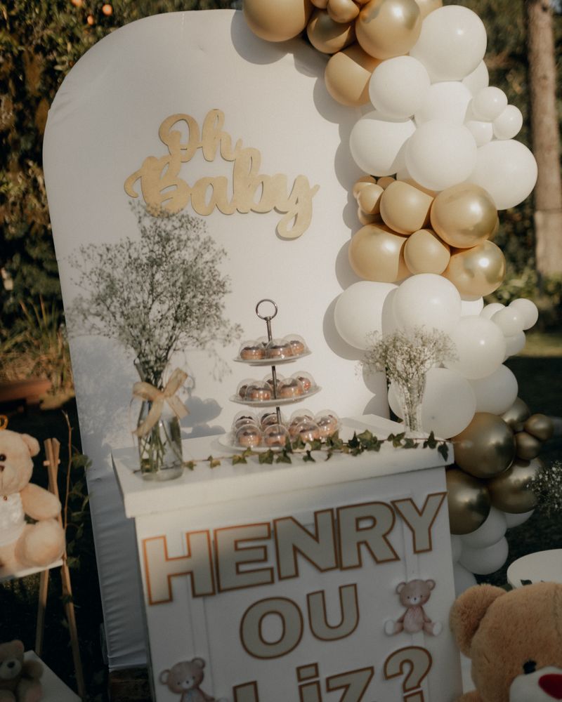 Gender reveal party setup with balloon decoration and teddy bears