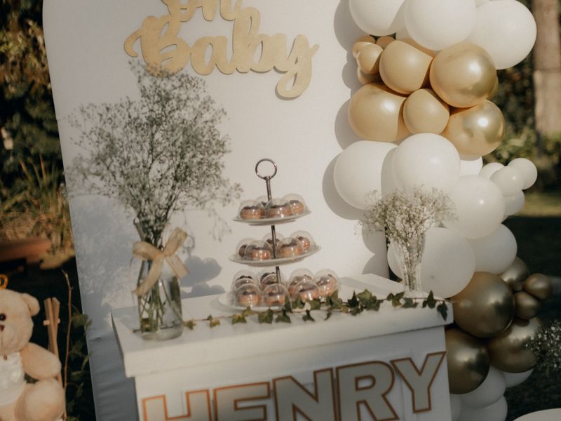 Gold and white balloon setup with teddy bears