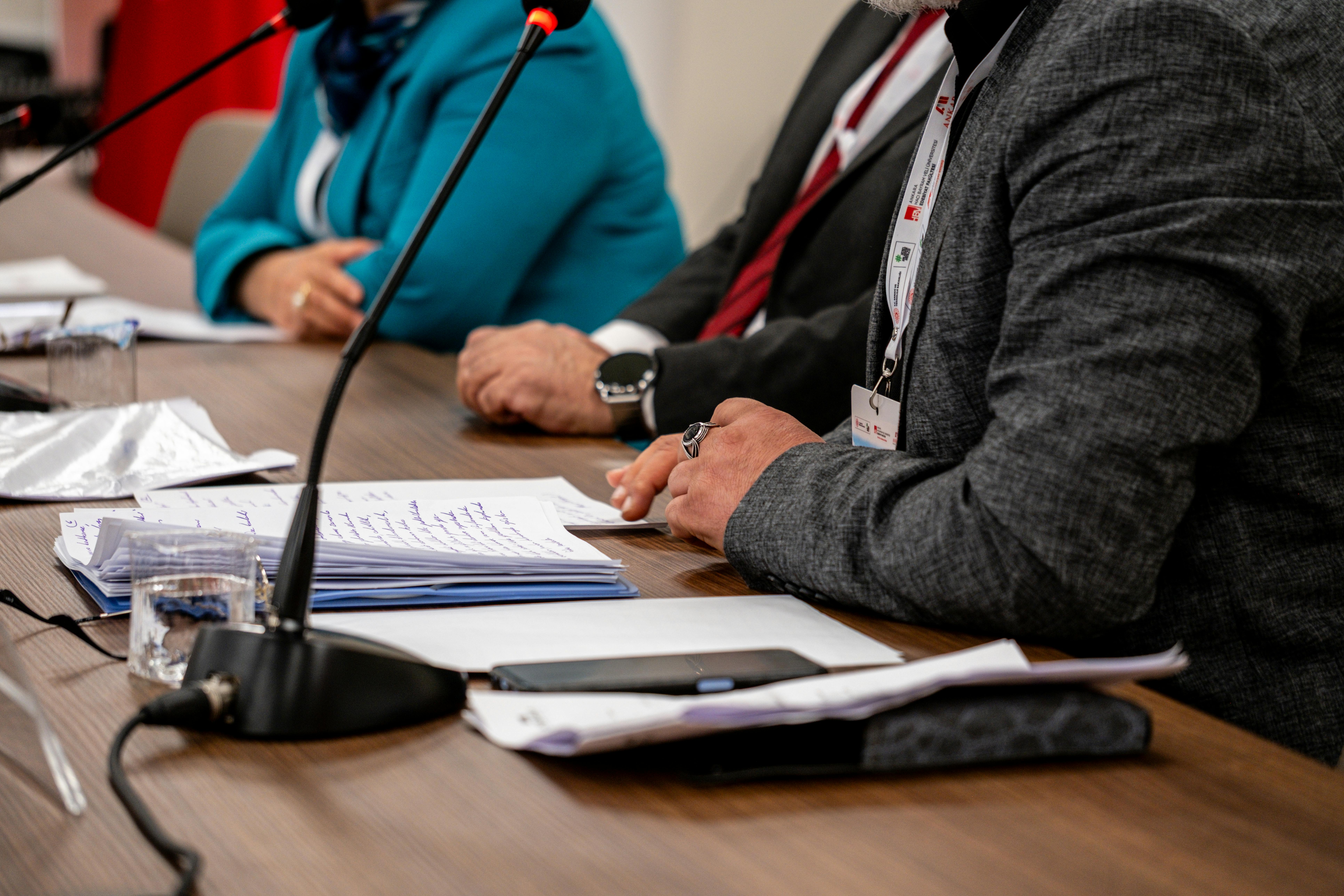 Close-up of professionals discussing documents at a business meeting in Ankara, Turkey.