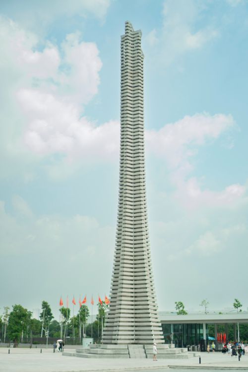 Free A striking modern architectural tower with a unique geometric design set against a bright sky. Stock Photo