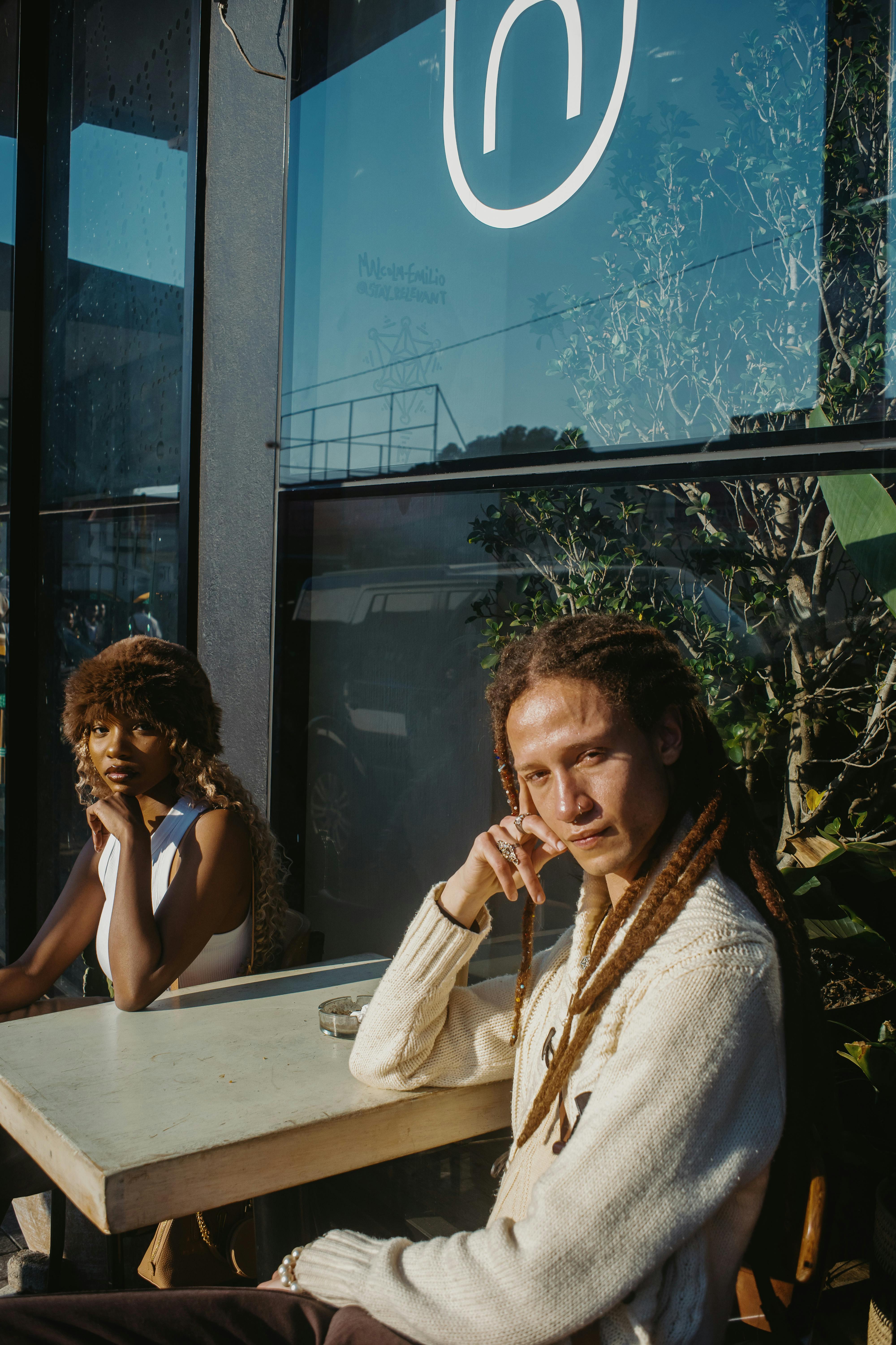 Contemporary fashion models enjoying a sunny day at a Johannesburg cafe.