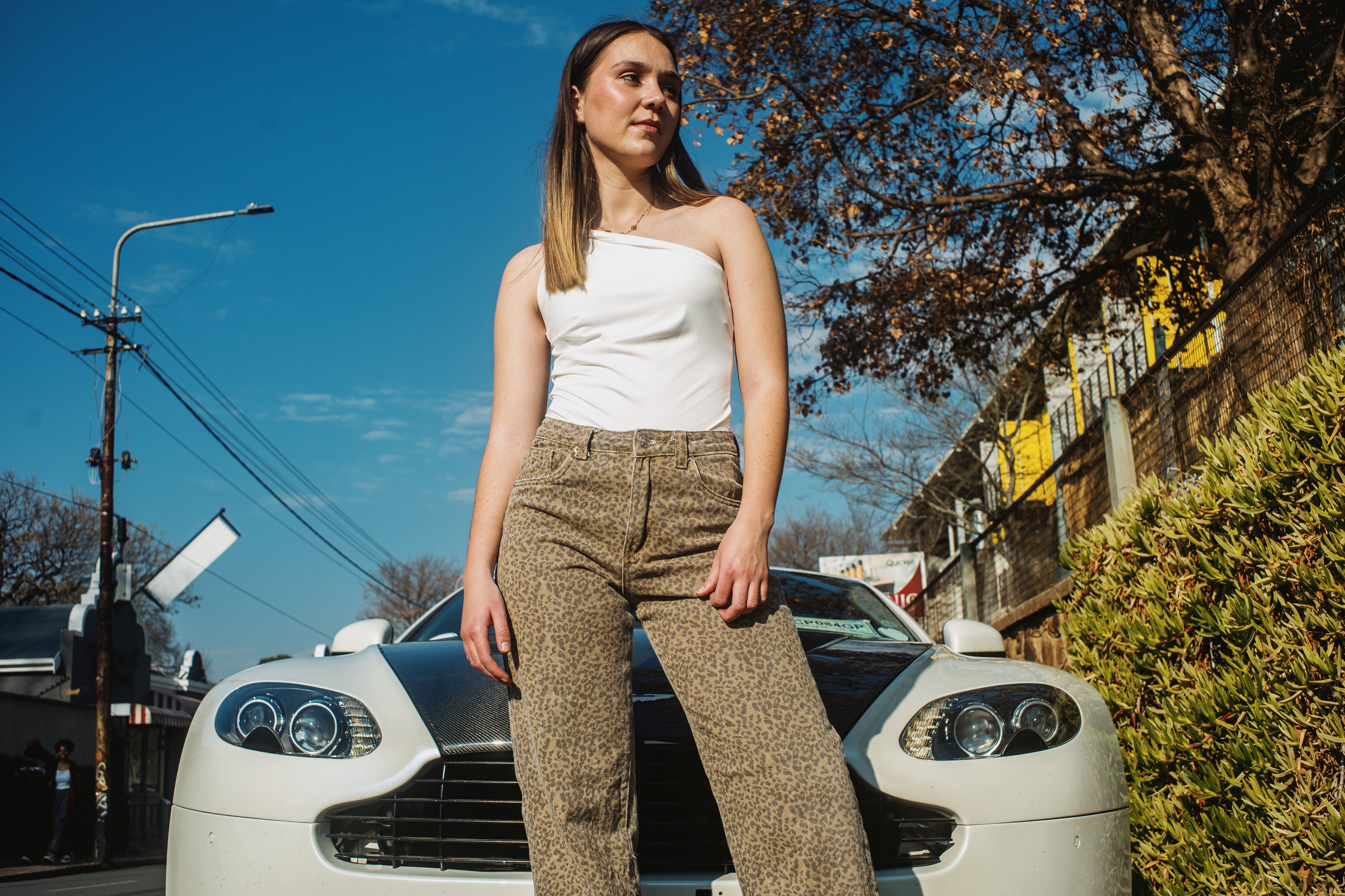Urban fashion shoot featuring a model with an Aston Martin in Johannesburg, South Africa.
