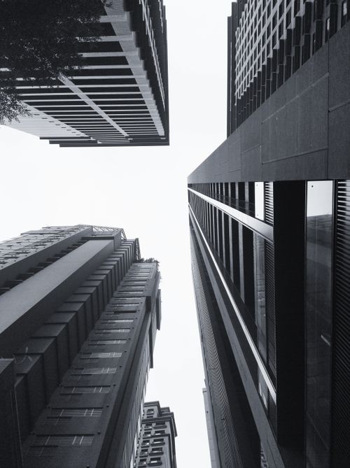 Free A dramatic low-angle view of towering skyscrapers in black and white. Stock Photo