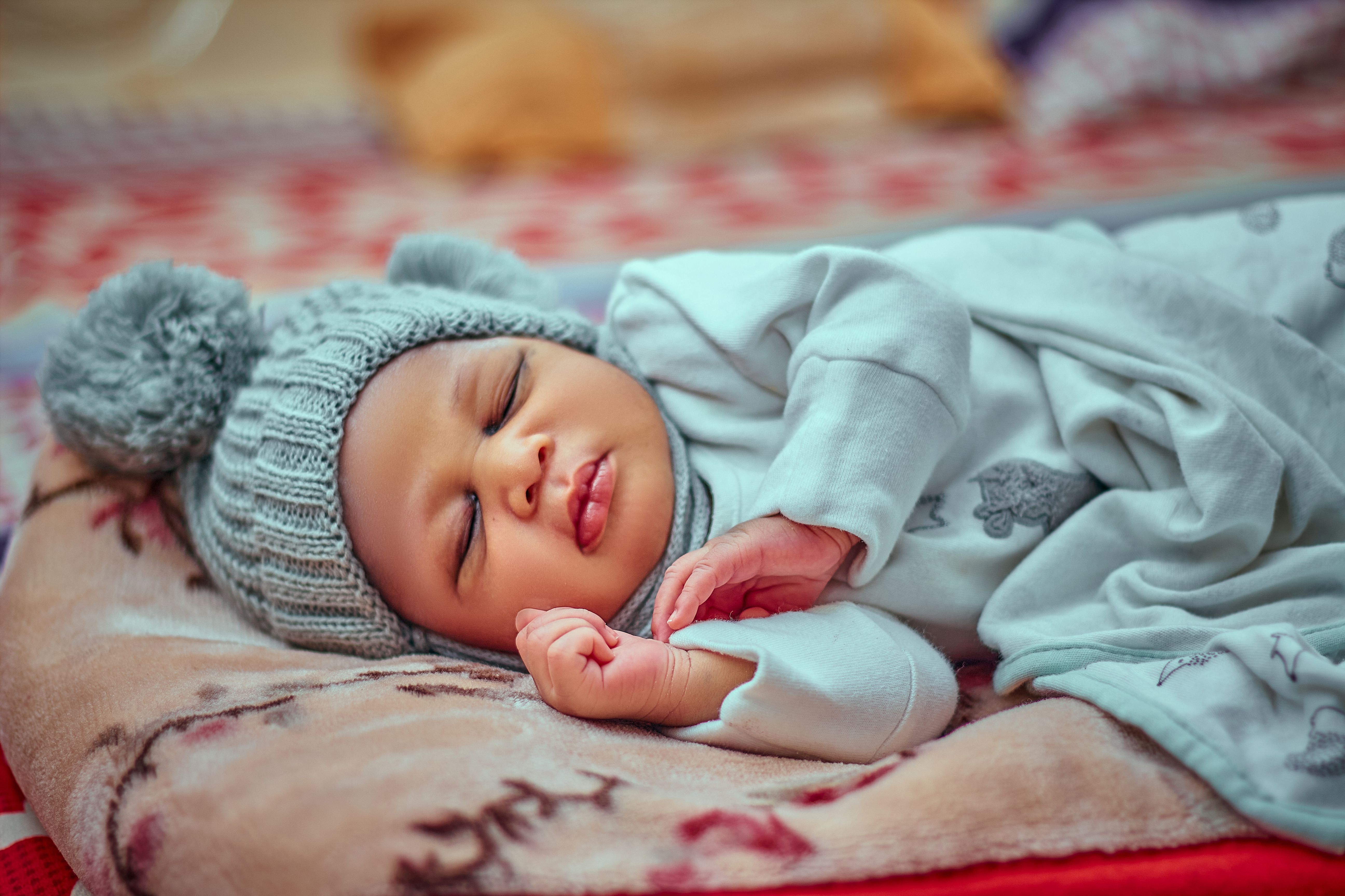 Peaceful baby sleeping in warm clothing during winter season, capturing innocence and tranquility.