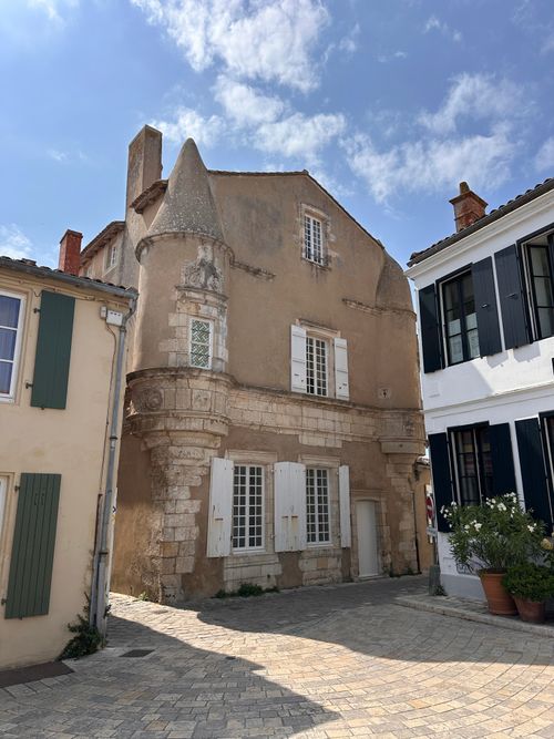 Free Charming ancient stone building under a bright summer sky in France. Stock Photo
