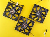 Three Computer Fans on Vibrant Yellow Background