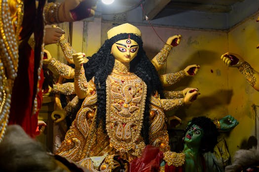 Intricate Goddess Durga idol preparation for Durga Puja in Kolkata, India.