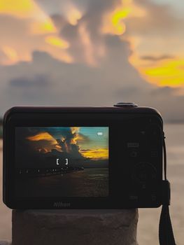 Camera screen displaying a colorful sunset, ideal for photography themes.