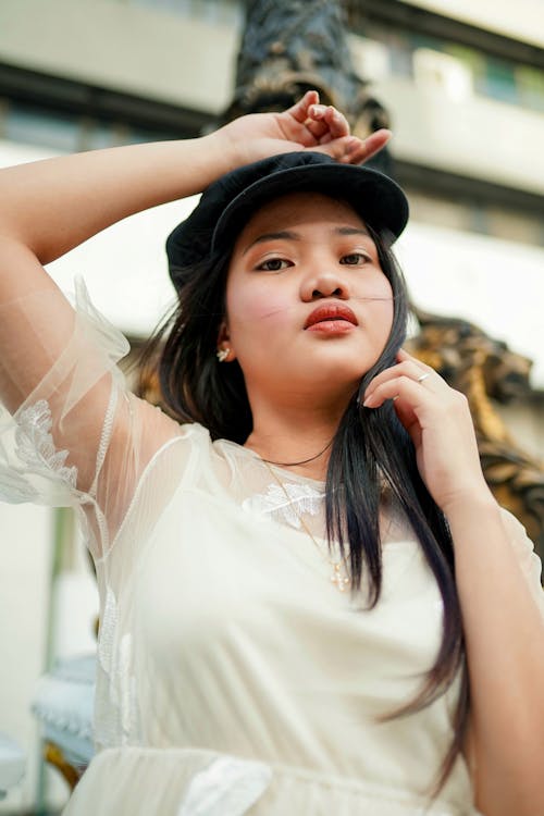 Woman Wearing White Dress and Black Hat