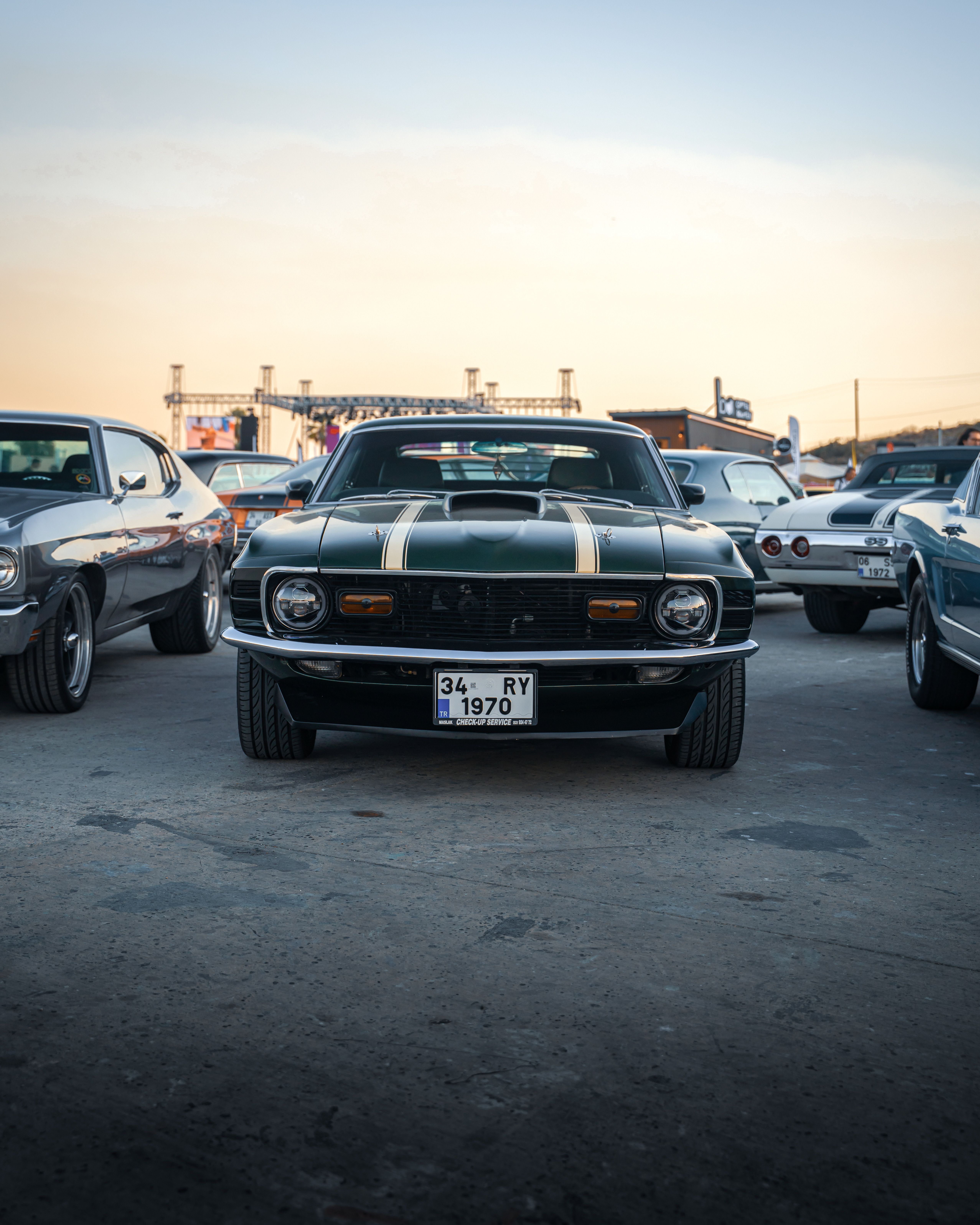 A lineup of vintage muscle cars at a car meet in İzmir, Türkiye.