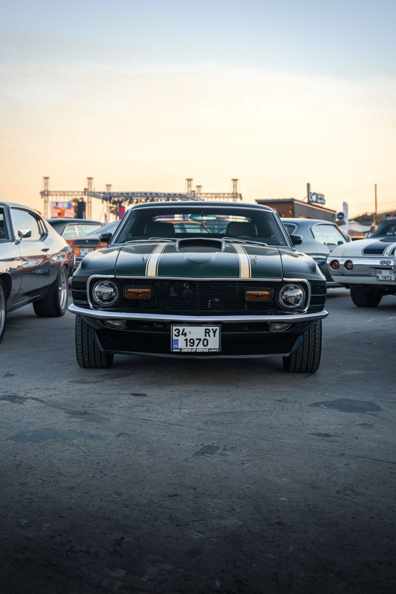 A lineup of vintage muscle cars at a car meet in İzmir, Türkiye.