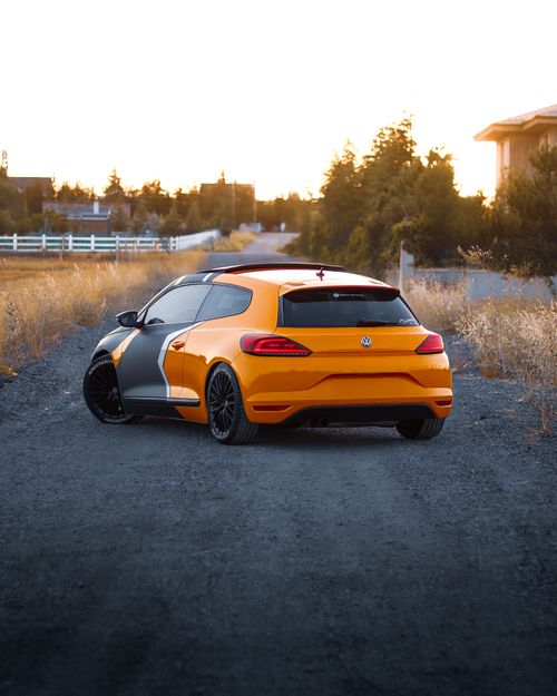 Free Bright orange and gray custom hatchback car parked on a rural road at sunset in Ankara, Turkey. Stock Photo