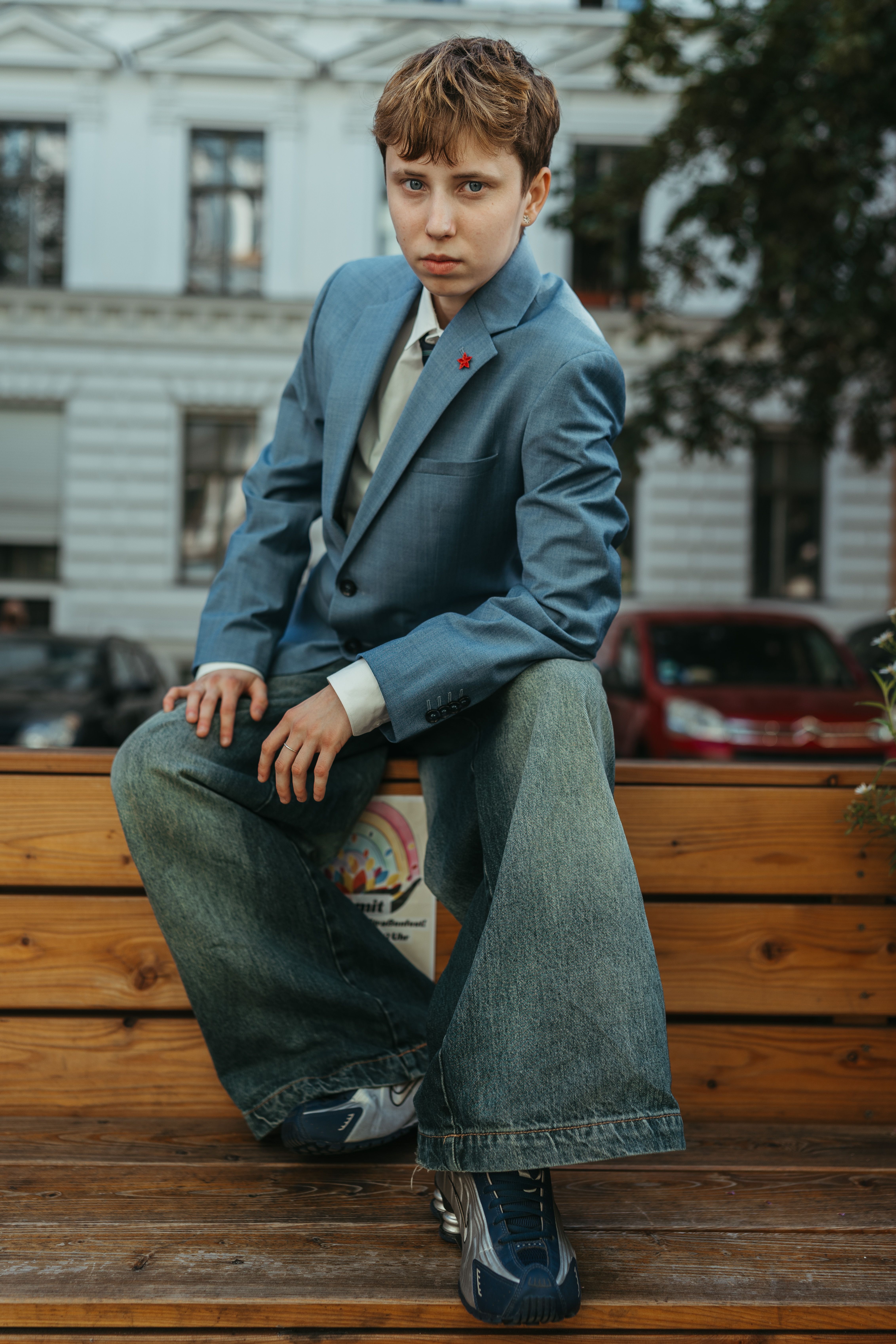 Stylish young model posing confidently in urban Berlin setting.