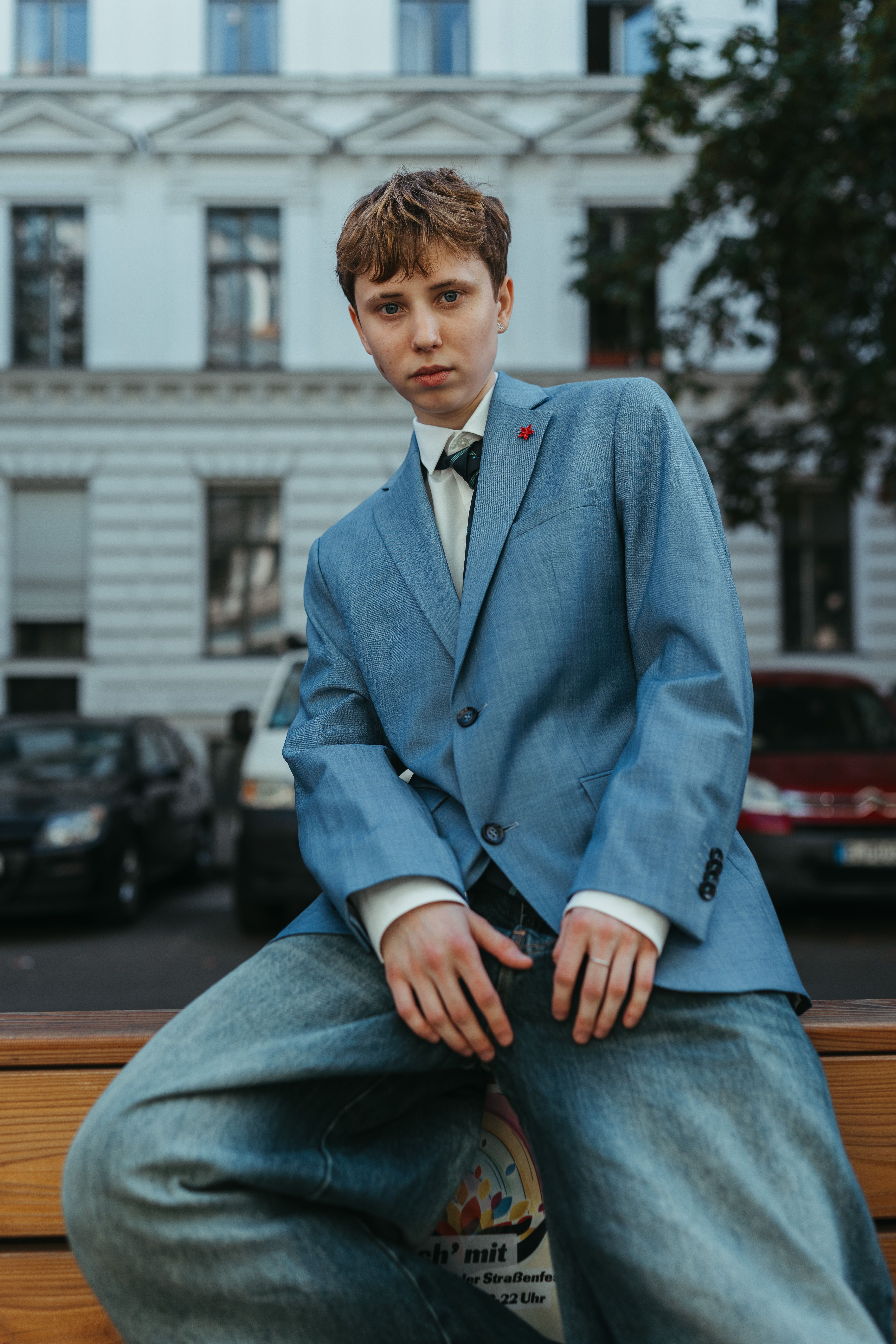 Stylish urban portrait of an adult in modern fashion in Berlin's cityscape.