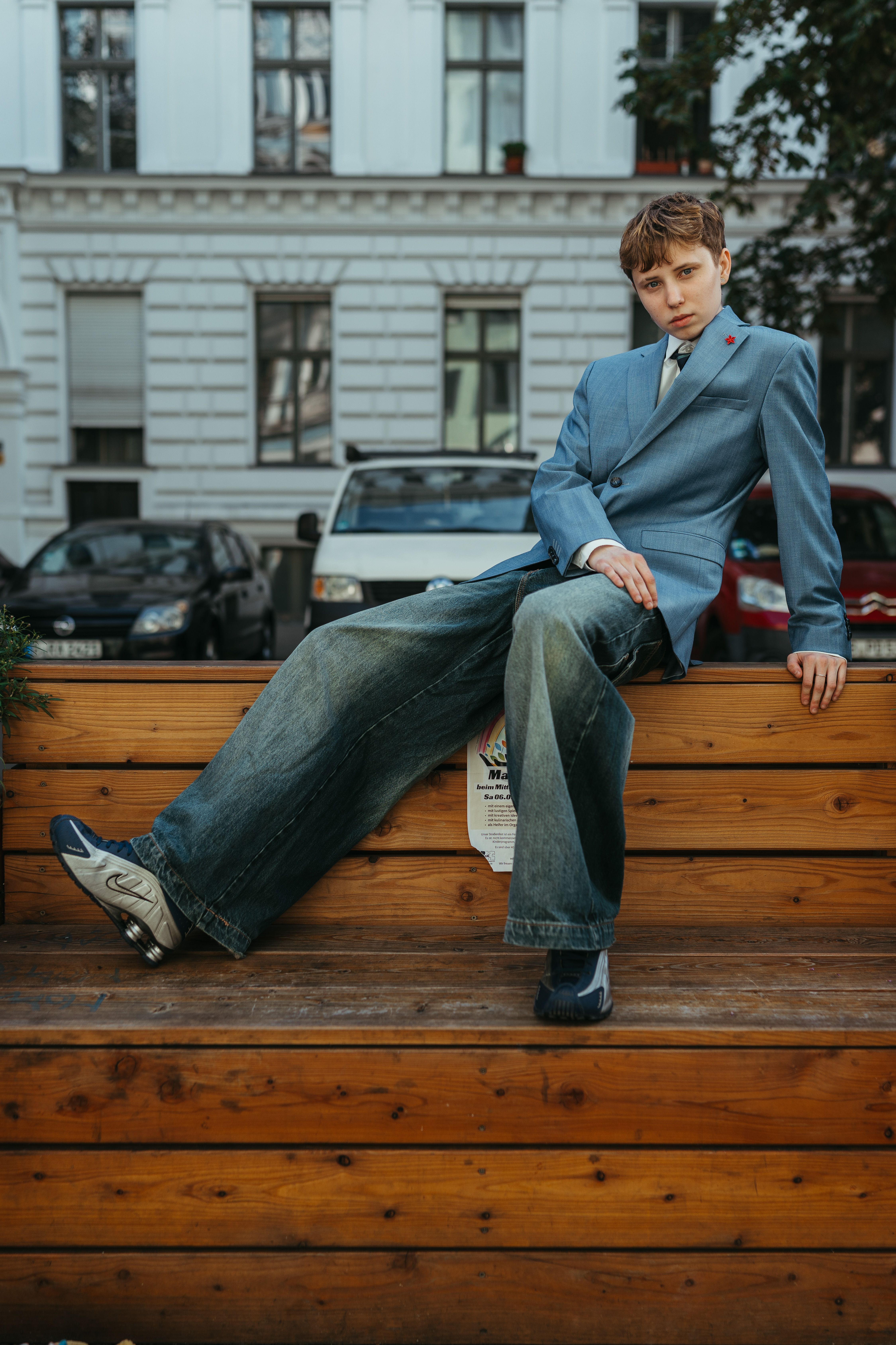 Stylish young adult posing outdoors in Berlin, exuding modern urban fashion vibes.