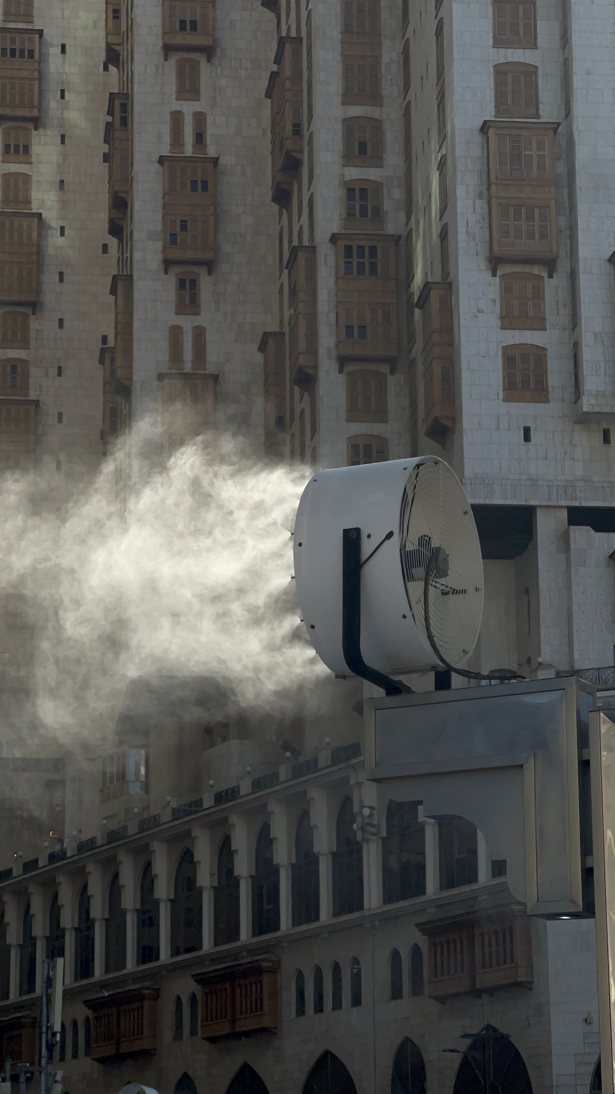 Large industrial misting fan spraying a fine cooling mist