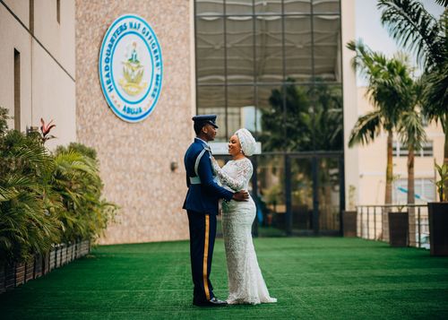 Free Couple embraces during wedding at headquarters with lush greenery. Stock Photo
