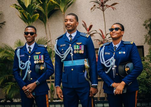 Free Three military officers in formal blue uniforms pose outdoors, showcasing badges and medals. Stock Photo
