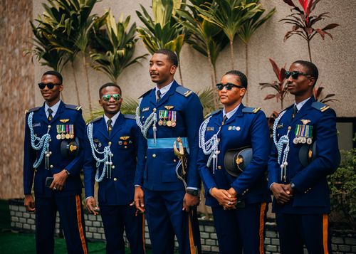 Free Five African military officers in decorated uniforms posing outdoors with plants. Stock Photo