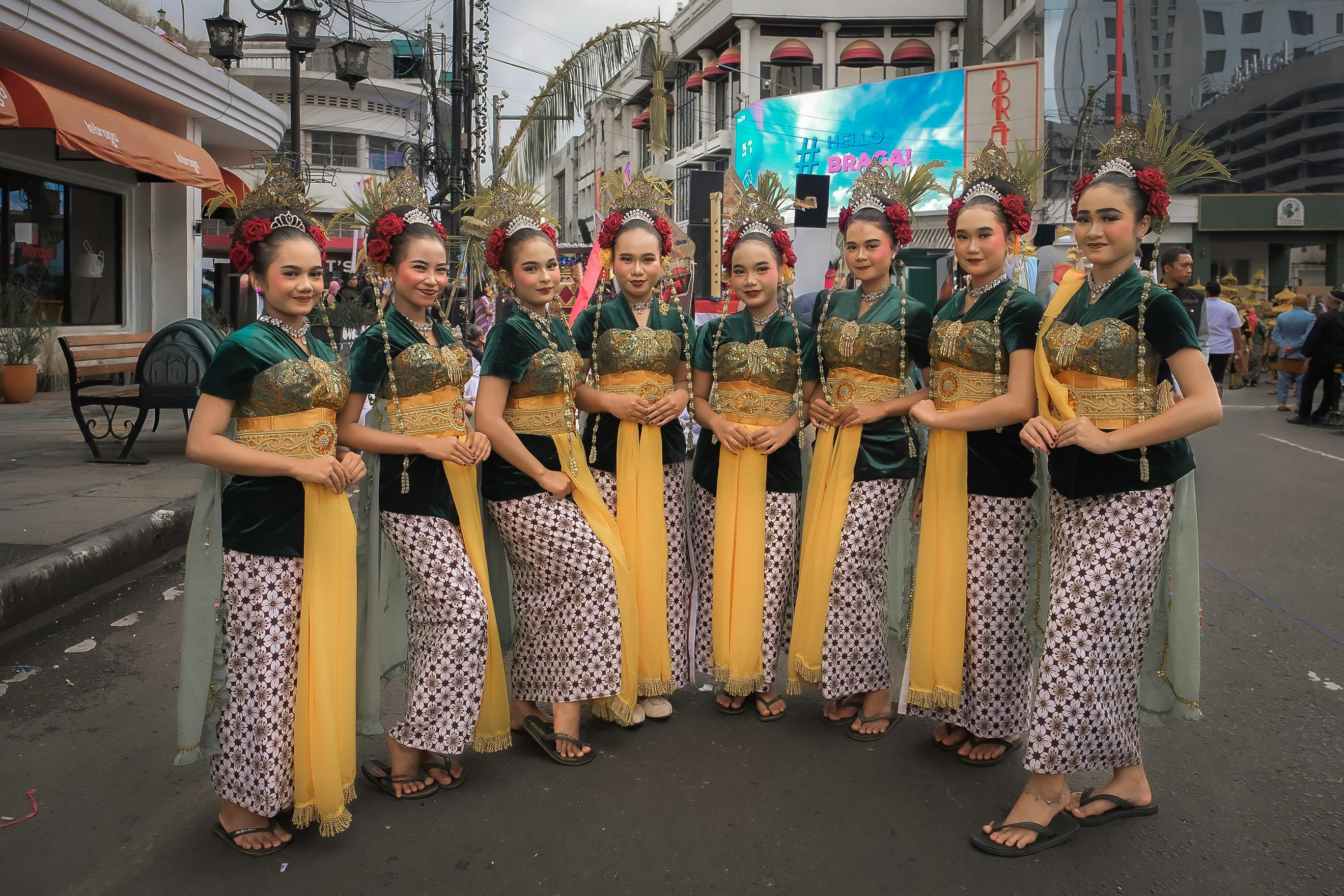 Group of traditional female dancers in vibrant costumes at Bandung street festival, highlighting cultural heritage.