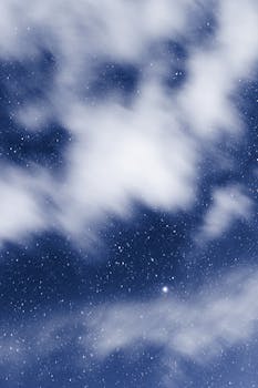 Capture of a star-filled night sky with ethereal clouds over Amecameca, Mexico.