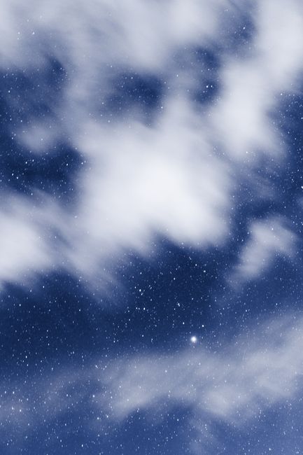 Capture of a star-filled night sky with ethereal clouds over Amecameca, Mexico.