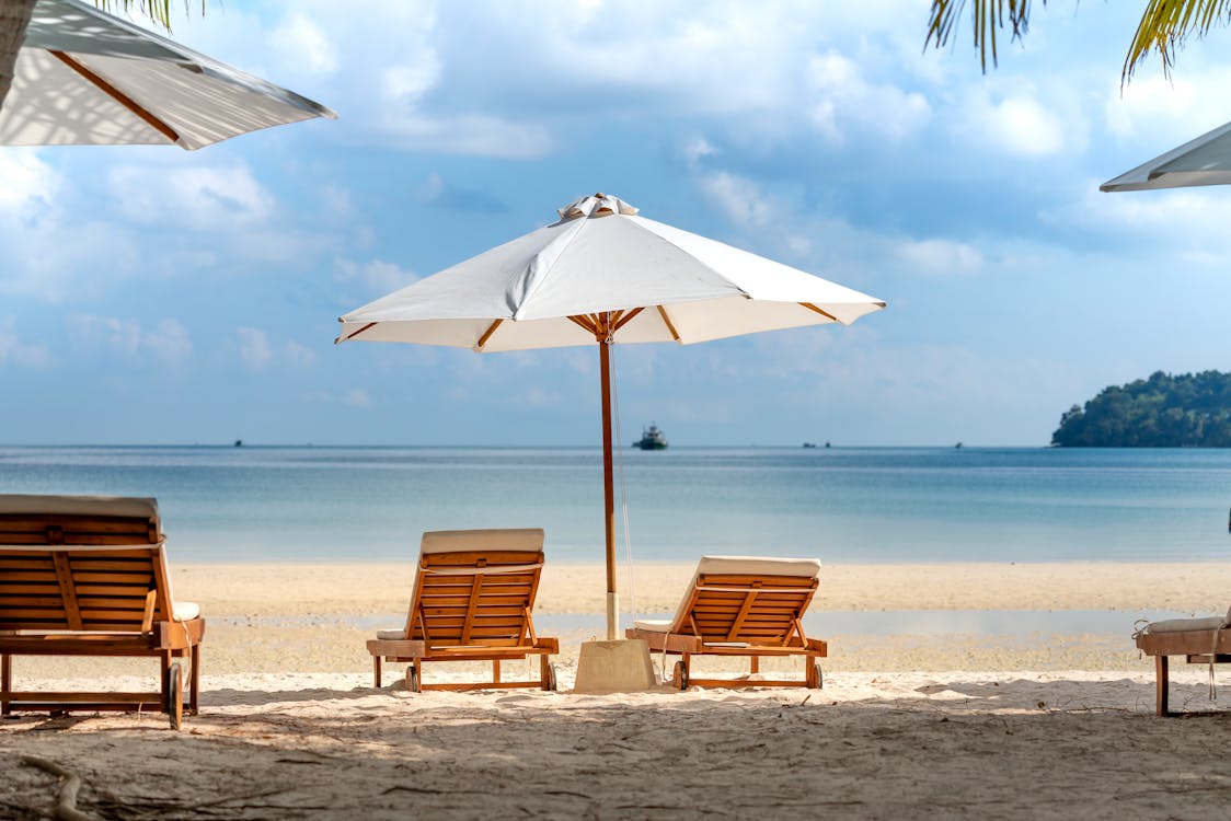 Tropical beach with deckchairs and umbrella