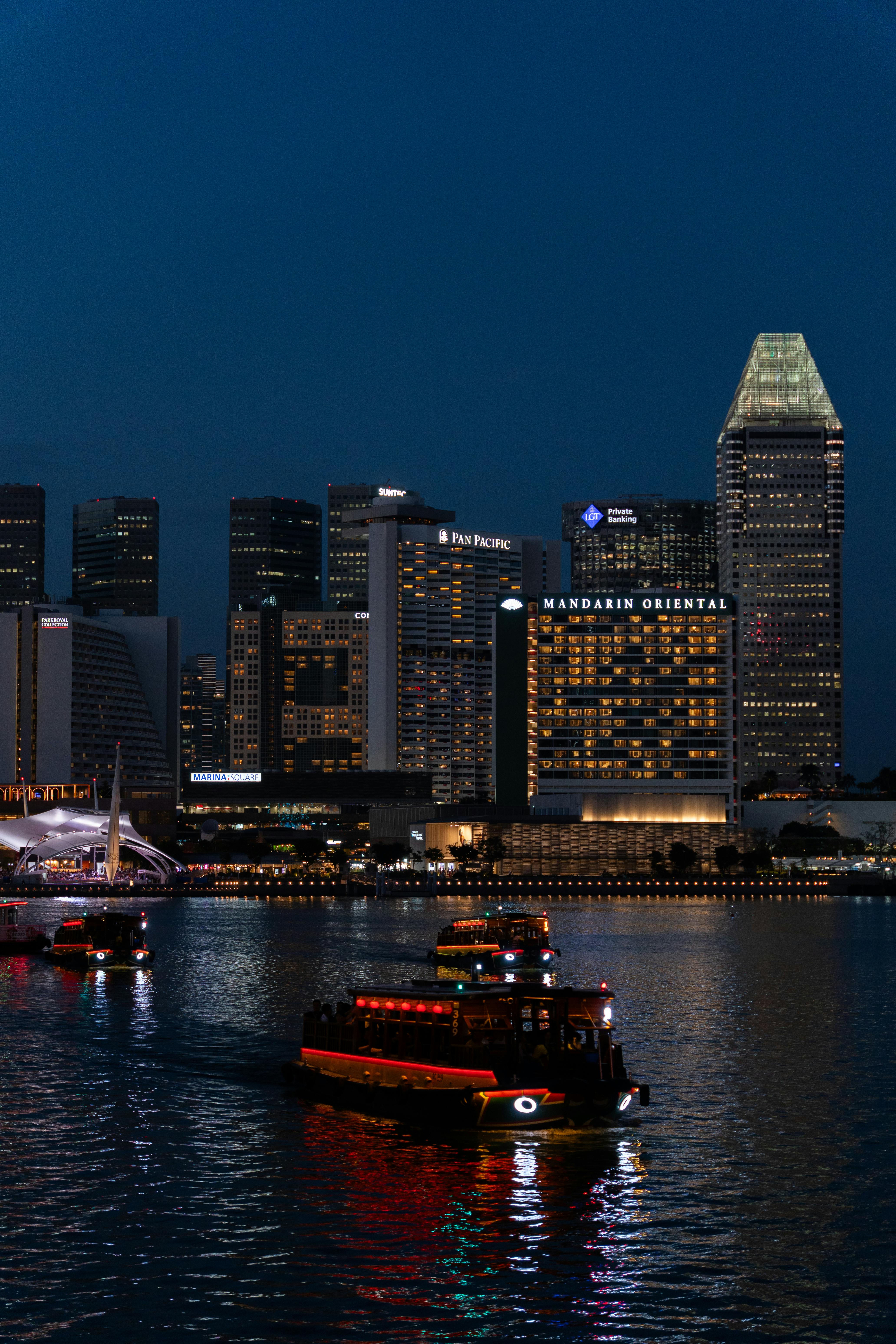 Singapore River cruise at night with Marina Bay city lights reflecting on the water