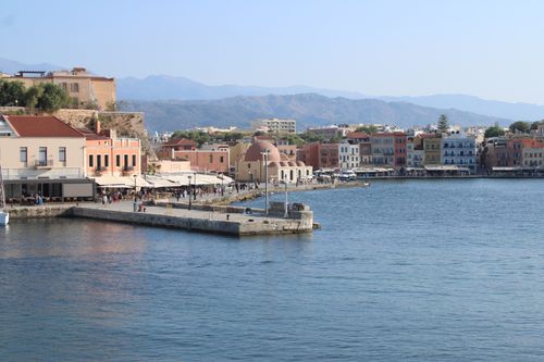 Free Scenic view of Chania harbor featuring traditional buildings and mountains in Greece. Stock Photo