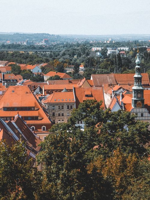 Free Aerial view of Pirna, Saxony showcasing historic red rooftops and lush greenery in a sunny summer setting. Stock Photo