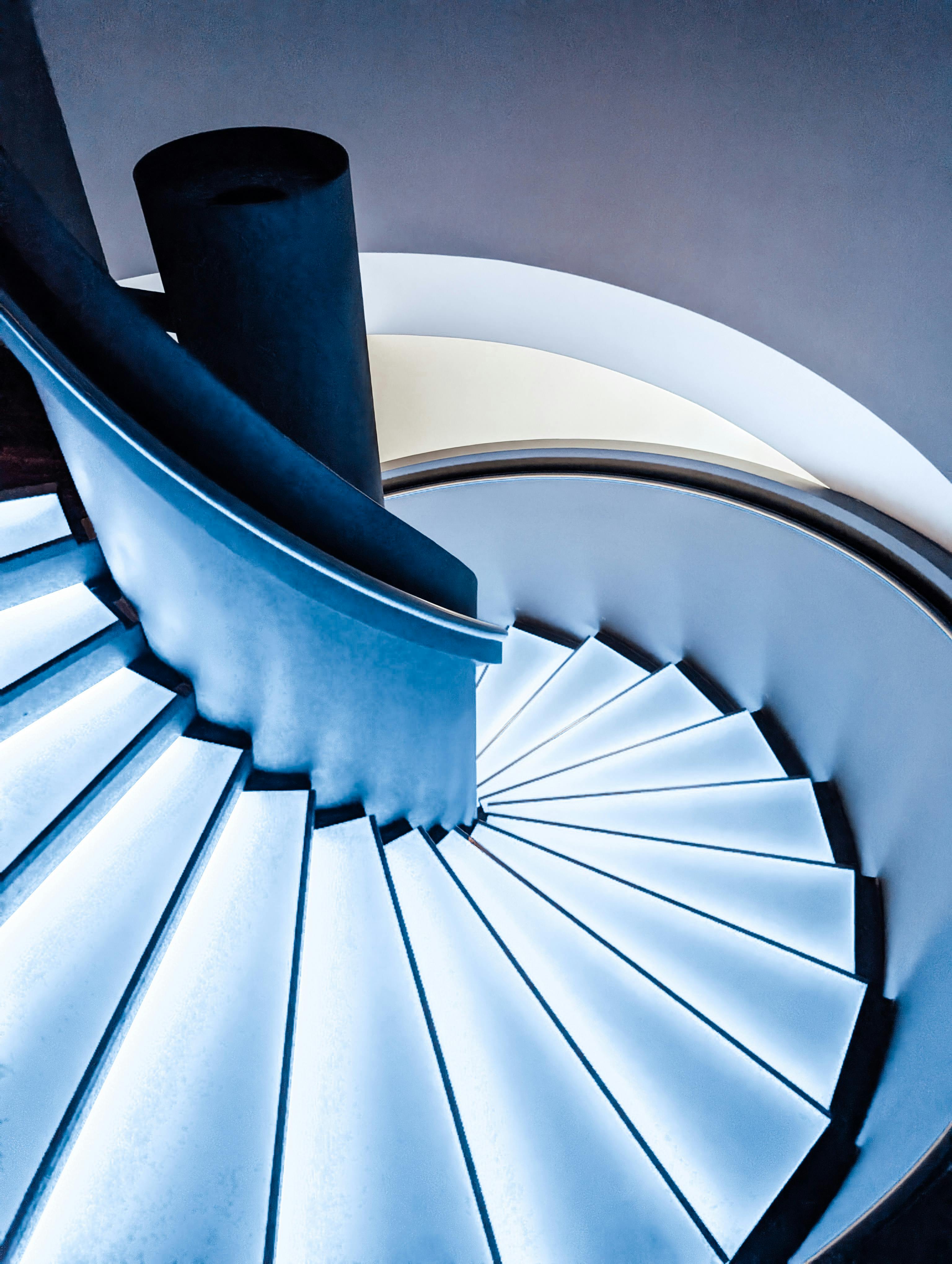 Dramatic floating spiral staircase in luxury home interior