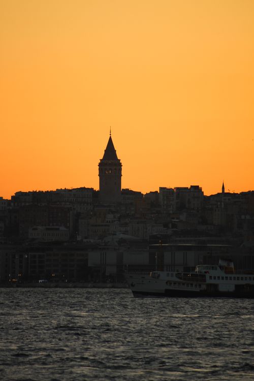 Free A breathtaking view of the Galata Tower silhouetted against a golden sunset sky over Istanbul. Stock Photo
