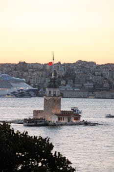 Scenic view of Maiden's Tower at sunset with the Istanbul skyline in the background.