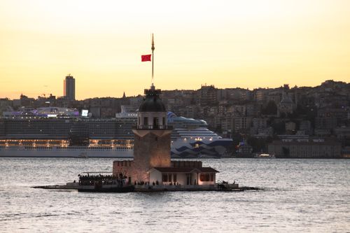Free Iconic Maiden's Tower at sunset with Istanbul cityscape and cruise ship in the background. Stock Photo