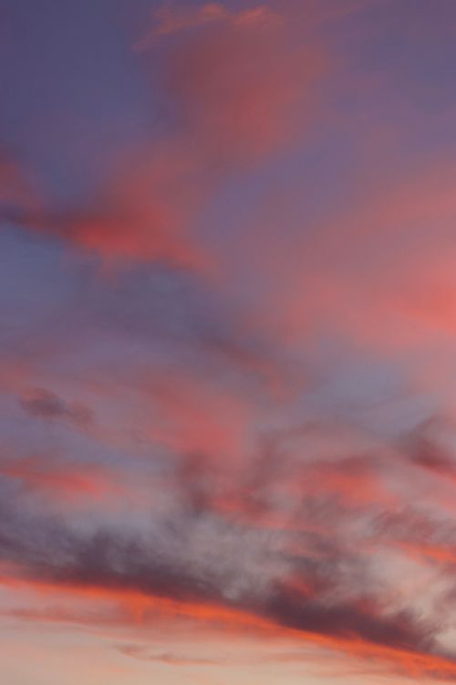 Free Vivid pink and purple sunset sky captured over Jönköping, Sweden with wispy clouds accentuating the tranquil evening. Stock Photo