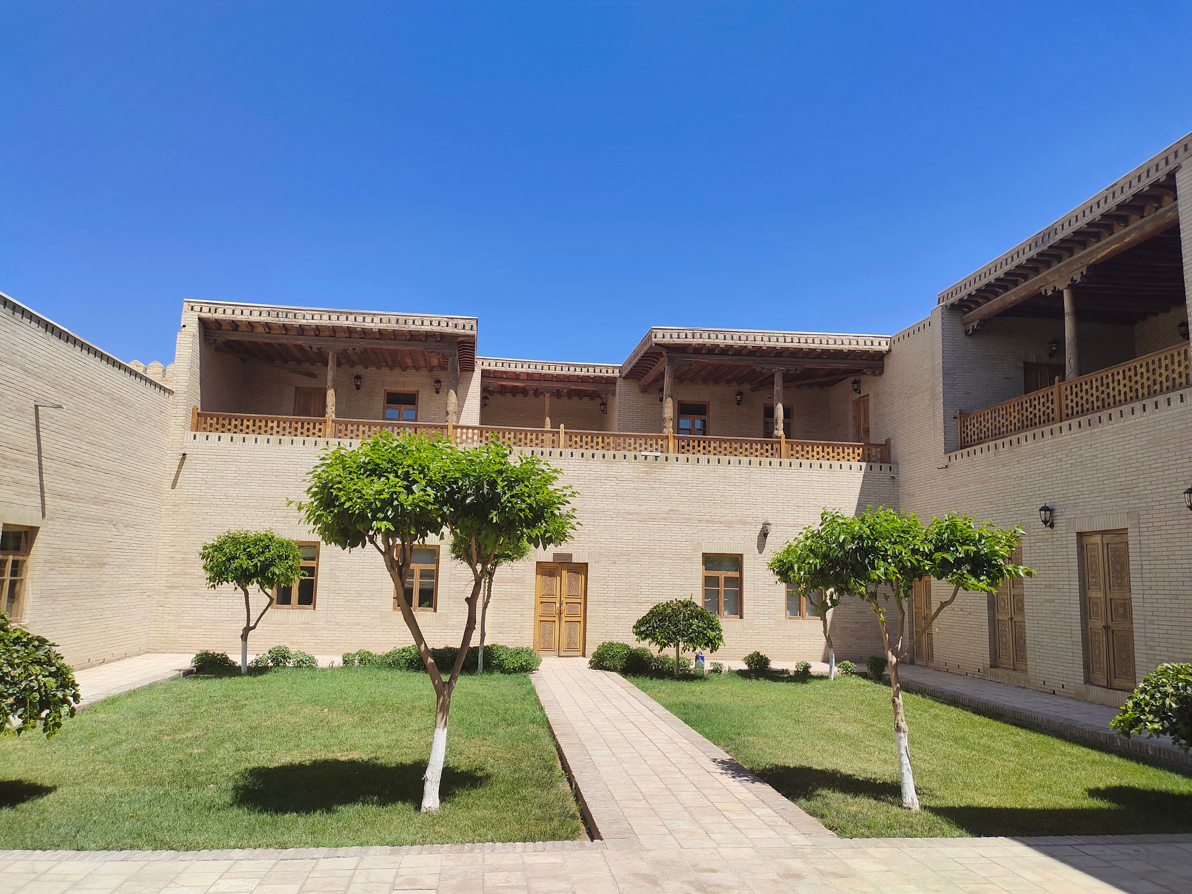 Empty sunlit courtyard at Medinat Habu in summer midday heat