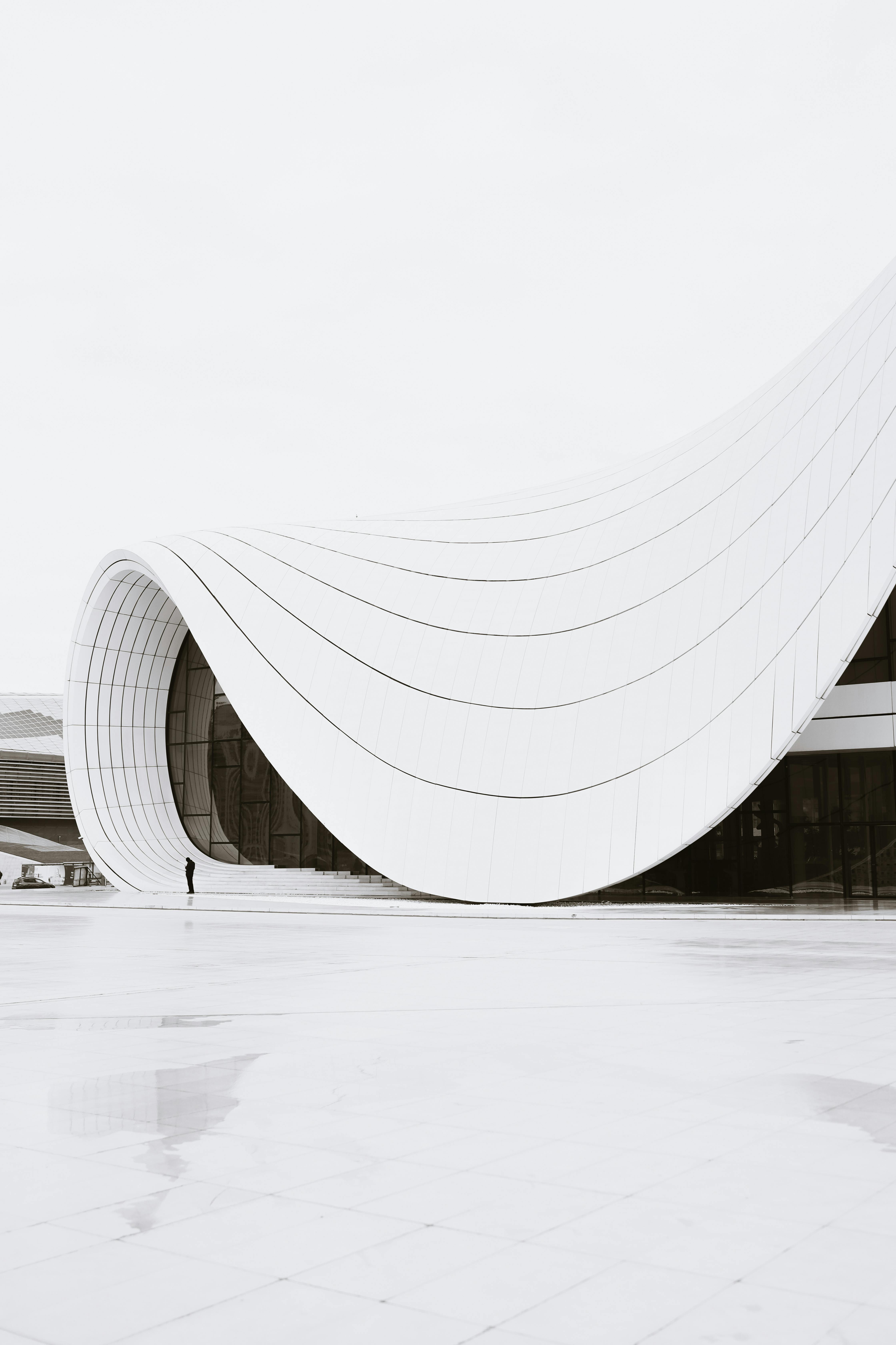 Minimalist view of the Heydar Aliyev Center's curving white facade in Baku, Azerbaijan.