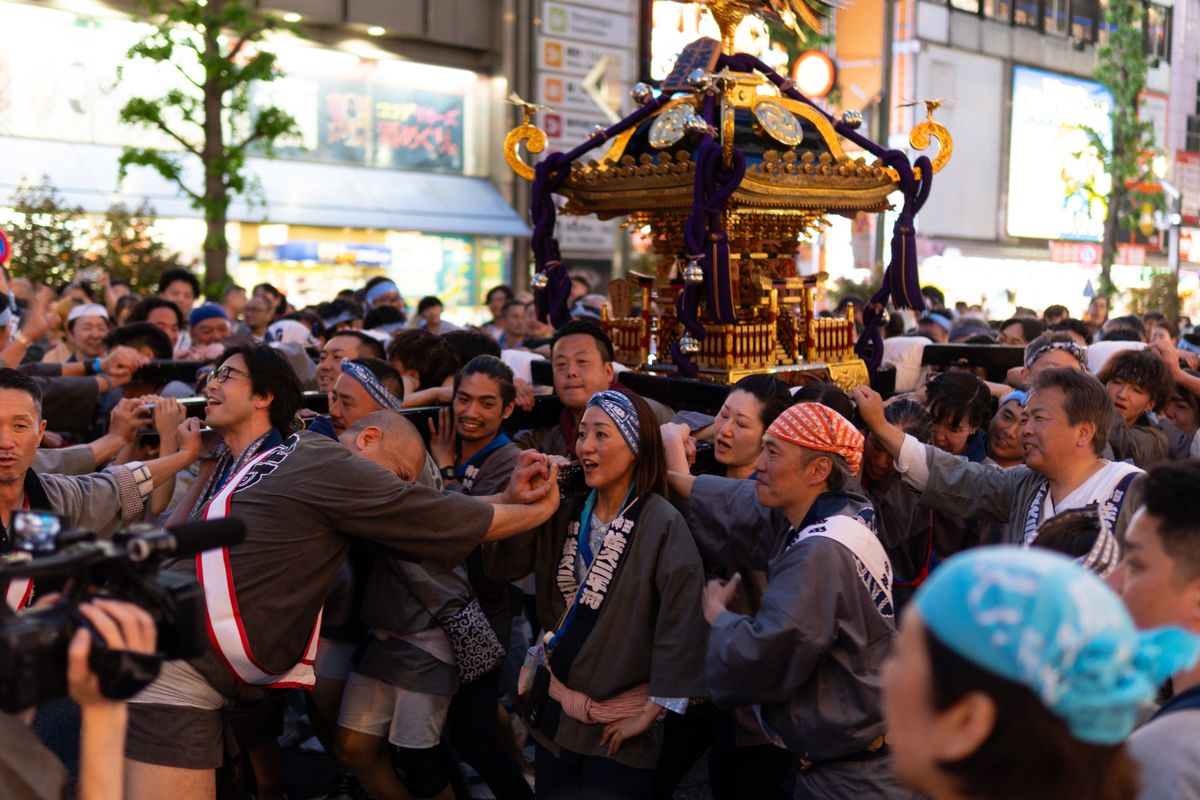 Vibrant Japanese festival parade with mikoshi bearers in traditional costumes — summer matsuri in Japan