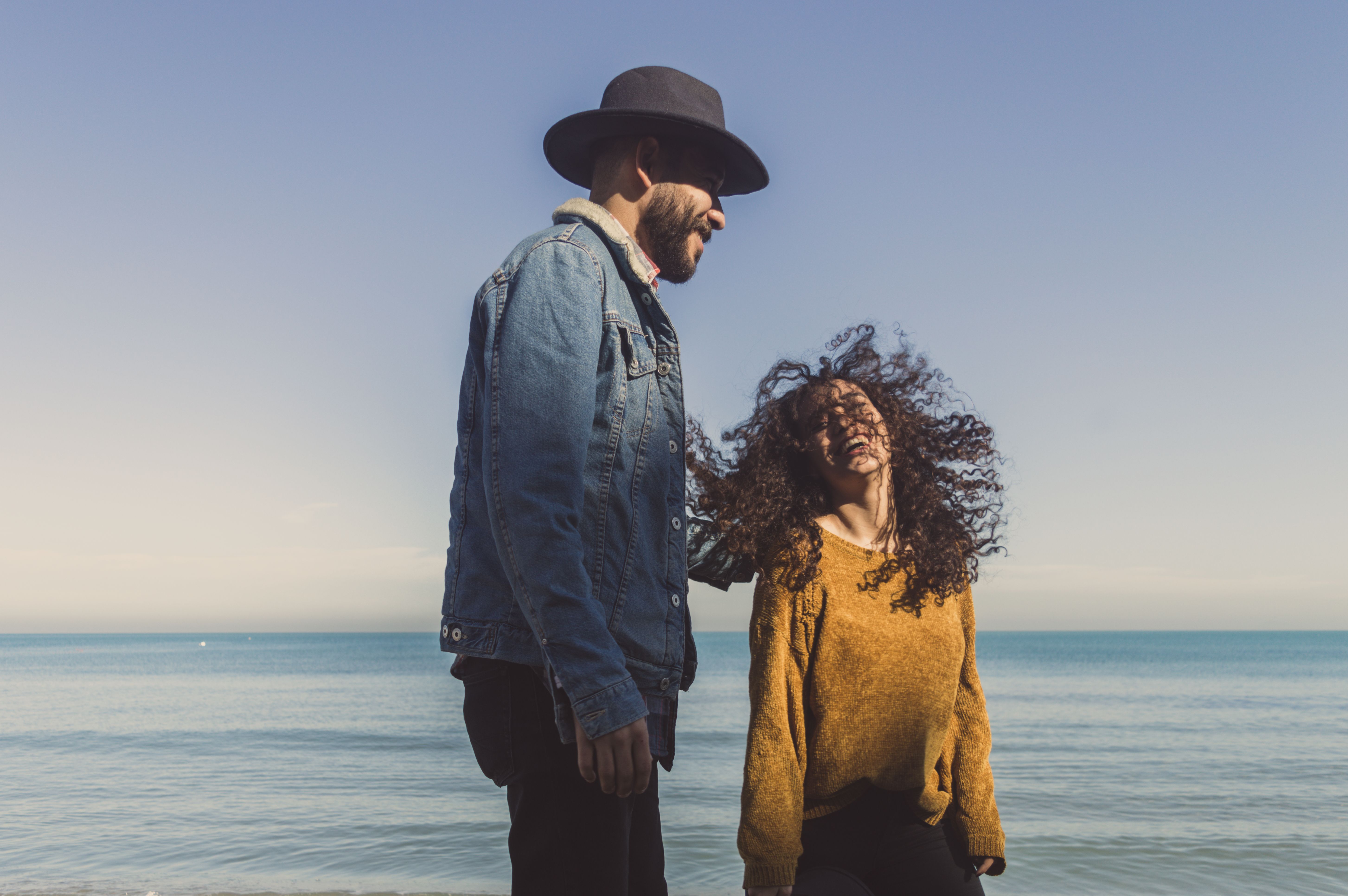 A Couple Standing on the Beach · Free Stock Photo
