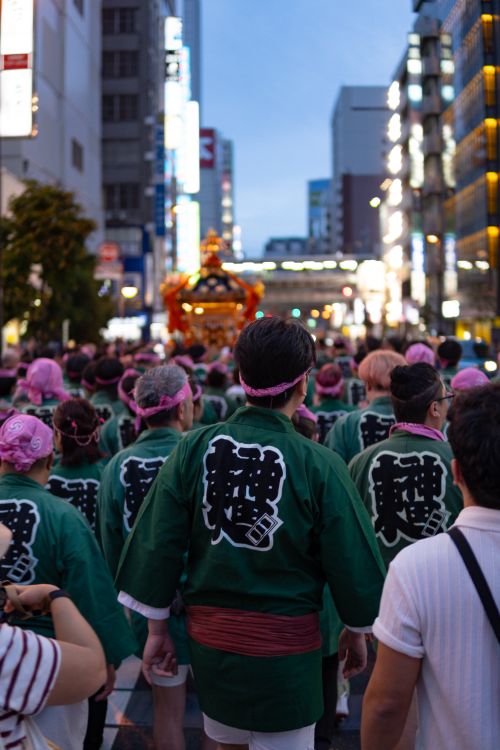 Free Crowd at a Japanese festival parade during the evening in a city street. Stock Photo