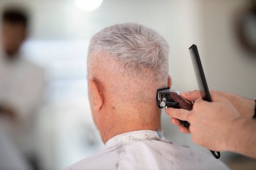 Free Person Using Hair Razor on Man's Hair Stock Photo