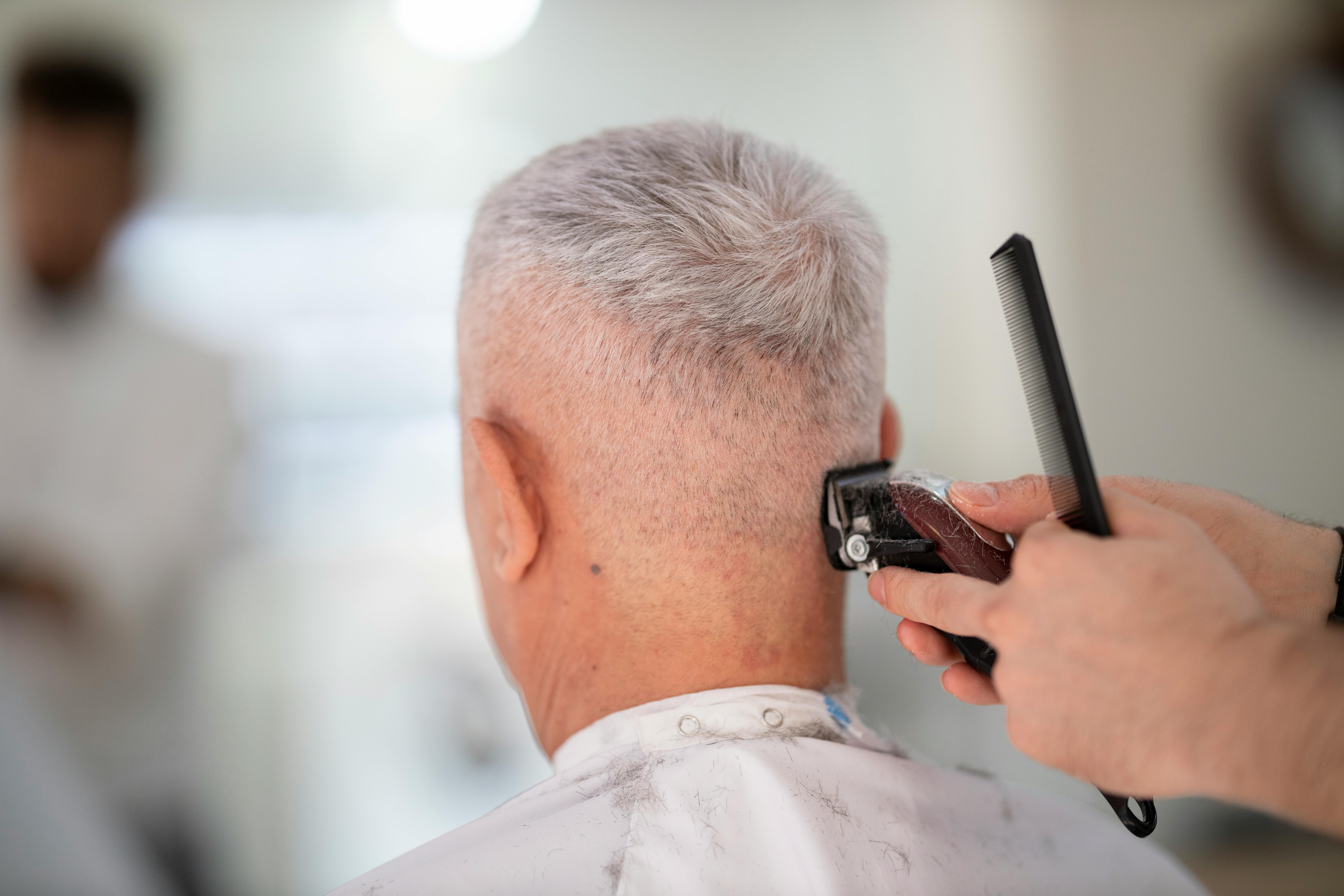 Person Using Hair Razor on Man's Hair · Free Stock Photo
