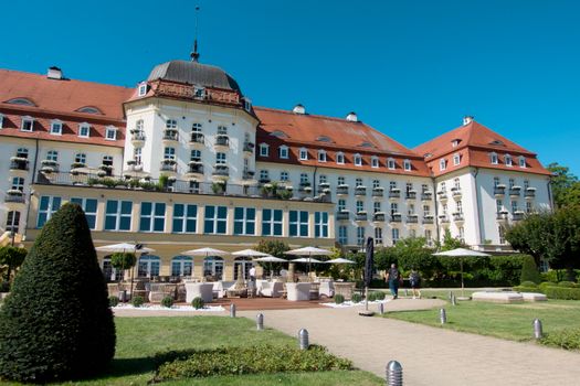 Elegant historic hotel with manicured gardens and classic architecture.