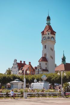 Charming view of historic tower and buildings in a coastal town on a bright summer day.