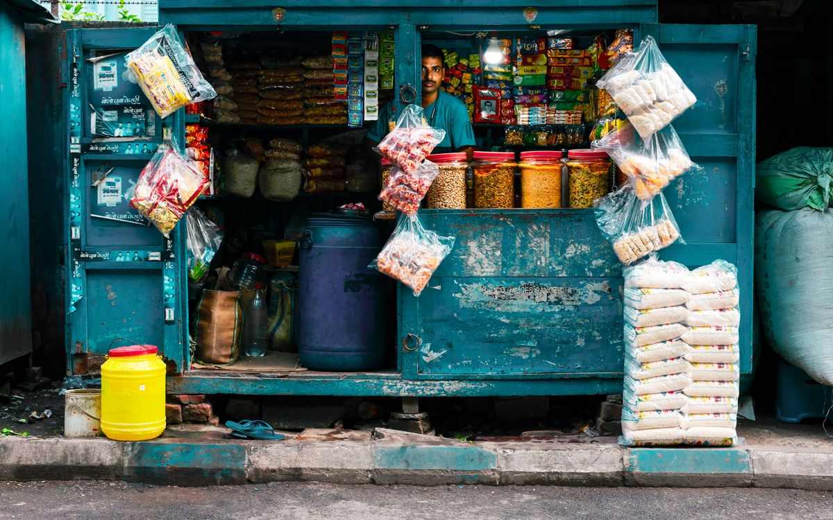 A vibrant street vendor stall in Kolkata selling snacks and essentials.