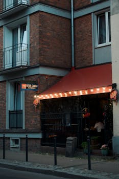 Cozy bistro entrance with warm lights and a rustic facade for inviting dining.