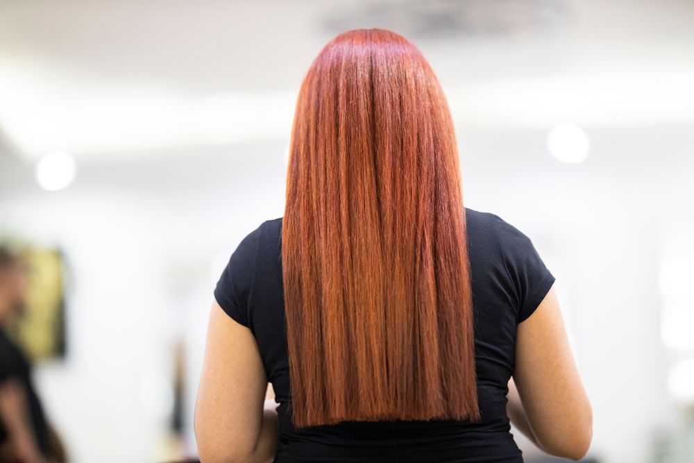 Finished straight copper-red hair, seen from behind