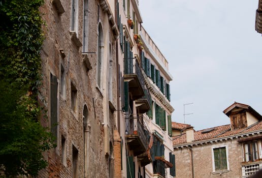 View of rustic buildings with balconies in a quaint European old town.