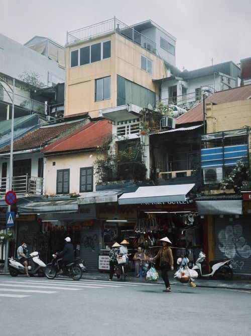Free Street view capturing daily life and architecture in Hanoi, showcasing local culture. Stock Photo